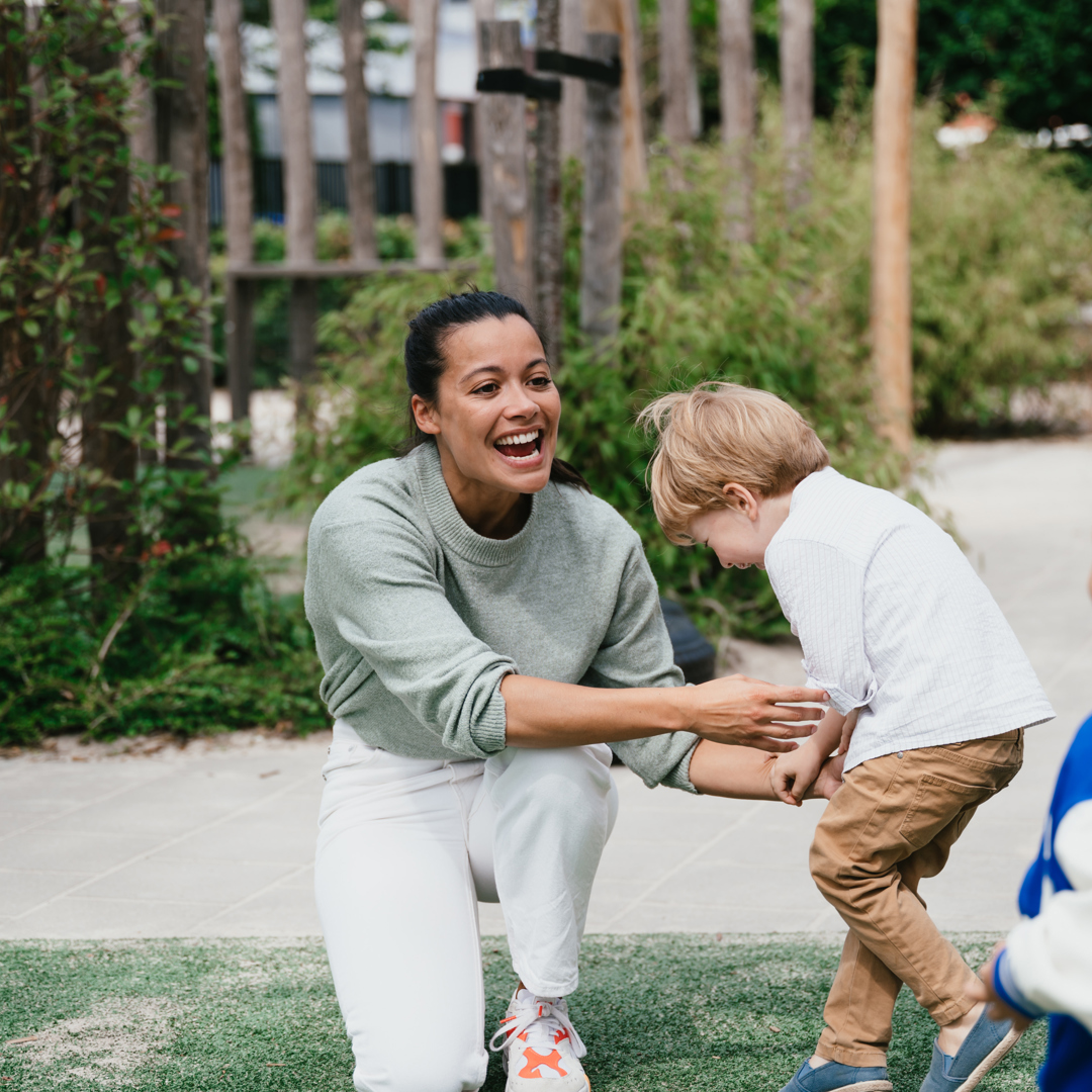 Pedagogical Professional and children at childcare compananny