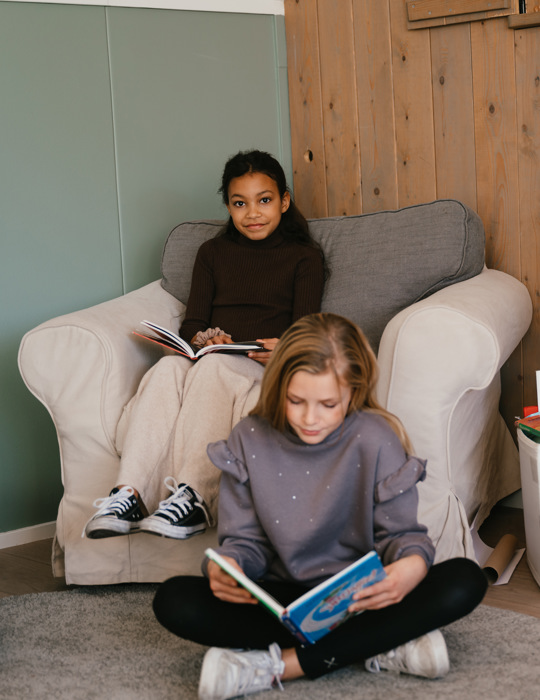 Twee meisjes lezen een boek op de BSO