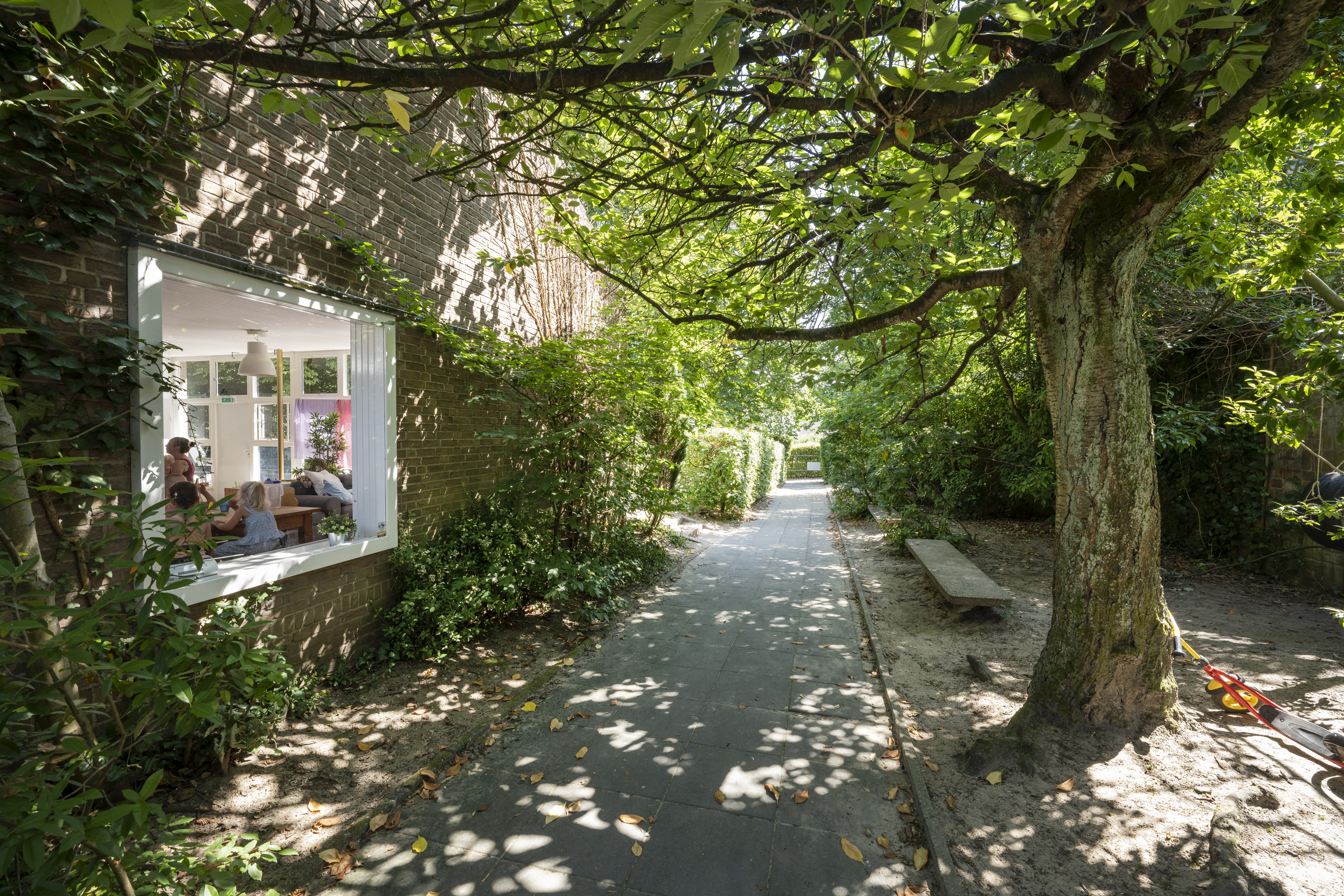 pad met bomen en planten naar kinderopvang locatie postpad