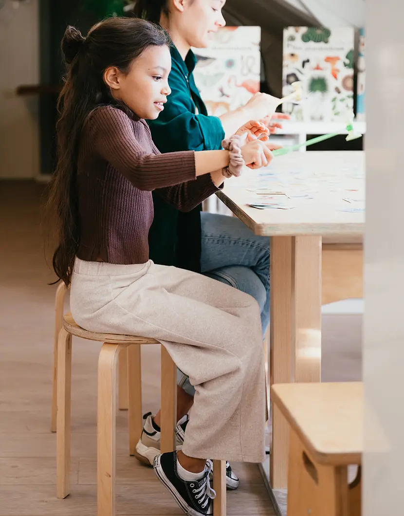 Meisje en vrouw spelen een kaartspel op de BSO